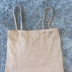 Cropped beige, ribbed tank.